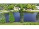 Picturesque aerial shot of a serene pond framed by mature trees, offering a peaceful and private setting at 6402 Beechnut Dr, Lakeland, FL 33813