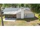 Features a screened patio, white chimney and lush green landscaping to enhance your outdoor relaxation at 6402 Beechnut Dr, Lakeland, FL 33813