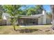 Features a screened patio, with lush green landscaping in the background at 6402 Beechnut Dr, Lakeland, FL 33813