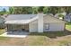 Features a screened patio, white chimney and lush green landscaping to enhance your outdoor relaxation at 6402 Beechnut Dr, Lakeland, FL 33813