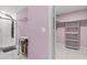 Updated bathroom features glass shower, marble floors, custom laundry cart, and walk-in closet at 6402 Beechnut Dr, Lakeland, FL 33813
