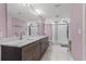 Bathroom featuring dual sink vanity, marble countertop, and a large shower at 6402 Beechnut Dr, Lakeland, FL 33813