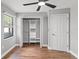 Bedroom featuring hardwood floors, closet with shelving, and a ceiling fan at 6402 Beechnut Dr, Lakeland, FL 33813