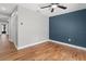 Spacious bedroom featuring hardwood floors and a blue accent wall at 6402 Beechnut Dr, Lakeland, FL 33813