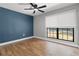 Bedroom featuring hardwood floors, a ceiling fan, and a window at 6402 Beechnut Dr, Lakeland, FL 33813