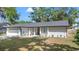 Well-maintained single-story home with a lush front lawn and beautiful landscaping at 6402 Beechnut Dr, Lakeland, FL 33813