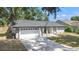 Inviting single-story home with a long driveway and a well-kept front yard at 6402 Beechnut Dr, Lakeland, FL 33813