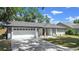 Beautiful single-story home with a two-car garage and green lawn at 6402 Beechnut Dr, Lakeland, FL 33813