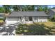 Charming single story home features a two-car garage, landscaped yard, and shade trees at 6402 Beechnut Dr, Lakeland, FL 33813