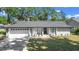 Charming single-story home with a well-manicured lawn, freshly painted exterior, and attached two-car garage at 6402 Beechnut Dr, Lakeland, FL 33813