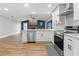 Bright kitchen featuring white cabinets, stainless steel appliances, and hardwood floors at 6402 Beechnut Dr, Lakeland, FL 33813