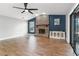 Open concept living room with a brick fireplace, hardwood floors, and backyard access at 6402 Beechnut Dr, Lakeland, FL 33813