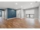 Bright and airy living room with wood floors, blue accent wall, and window view at 6402 Beechnut Dr, Lakeland, FL 33813