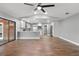 Open concept living room with a kitchen, hardwood floors, and backyard access at 6402 Beechnut Dr, Lakeland, FL 33813