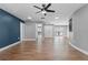 Open-concept living room showcasing wood floors, modern lighting, and an accent wall at 6402 Beechnut Dr, Lakeland, FL 33813