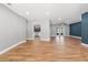 Spacious living room featuring wood floors, gray walls, and views into kitchen at 6402 Beechnut Dr, Lakeland, FL 33813