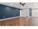 Stylish living room with modern ceiling fan, wood floors, and blue accent wall at 6402 Beechnut Dr, Lakeland, FL 33813