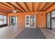 Enclosed patio with wood paneled ceiling, tile flooring, and views into the house at 6402 Beechnut Dr, Lakeland, FL 33813
