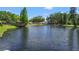 Calm pond view surrounded by lush greenery, creating a peaceful and serene atmosphere at 6402 Beechnut Dr, Lakeland, FL 33813