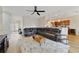 Open-concept living room featuring a large sectional sofa, ceiling fan, and wood-look flooring at 741 Mystic Oaks Ln, Deland, FL 32724