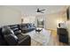 Comfortable living room with sliding glass doors, ceiling fan, and an open view of the kitchen at 741 Mystic Oaks Ln, Deland, FL 32724
