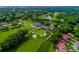 Aerial view of a golf course community with winding fairways, serene lakes, and beautifully landscaped greens at 7423 Elsworth Ct, Orlando, FL 32819