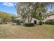 Large backyard with mature trees and a well-maintained lawn at 7423 Elsworth Ct, Orlando, FL 32819