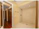 Bright bathroom featuring a tiled walk-in shower and wood cabinets at 7423 Elsworth Ct, Orlando, FL 32819