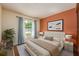 Cozy bedroom featuring a comfy bed with white headboard and ample natural light at 7423 Elsworth Ct, Orlando, FL 32819