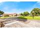 Community clubhouse featuring a tile roof, well-kept grounds, and ample parking for residents and guests at 7423 Elsworth Ct, Orlando, FL 32819