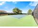 Well-maintained tennis court surrounded by lush greenery and fencing, perfect for recreational play at 7423 Elsworth Ct, Orlando, FL 32819