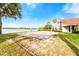 Sandy volleyball court next to a lake offering a fun recreational amenity for residents to enjoy outdoors at 7423 Elsworth Ct, Orlando, FL 32819
