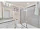 Stylish bathroom with granite vanity top and a glass enclosed shower at 7487 Oakmoss Loop, Davenport, FL 33837
