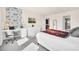 Bright bedroom with a dedicated desk area, stylish wallpaper, and views through an open en-suite bathroom at 7487 Oakmoss Loop, Davenport, FL 33837