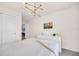 Bedroom featuring white furniture, a television, and stylish light fixture at 7487 Oakmoss Loop, Davenport, FL 33837