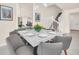 Open concept dining room featuring a modern chandelier, decor, and staircase access to the second floor at 7487 Oakmoss Loop, Davenport, FL 33837