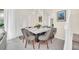 Contemporary dining area with modern furniture, art pieces, and access to outdoor patio area at 7487 Oakmoss Loop, Davenport, FL 33837