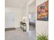 Bright foyer with a view of the bedroom and decorative painting at 7487 Oakmoss Loop, Davenport, FL 33837