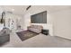 Open game zone features sofa, TV, stylish decor and a gaming rug at 7487 Oakmoss Loop, Davenport, FL 33837