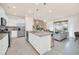Stylish kitchen with granite countertops, stainless steel appliances, and open view to the living room at 7487 Oakmoss Loop, Davenport, FL 33837