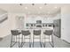 Beautiful kitchen featuring white cabinetry, granite countertops, stainless steel appliances, large island and pendant lighting at 7487 Oakmoss Loop, Davenport, FL 33837
