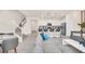 Open living room space connects to the kitchen with bar seating and staircase at 7487 Oakmoss Loop, Davenport, FL 33837