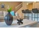 Chic living room boasts a decorative vase on a white coffee table and bar seating in the kitchen at 7487 Oakmoss Loop, Davenport, FL 33837