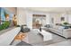 Comfortable living room with television, backyard views, and open dining space at 7487 Oakmoss Loop, Davenport, FL 33837