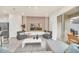 Stylish living room with neutral tones, TV, backyard views, and accent seating at 7487 Oakmoss Loop, Davenport, FL 33837