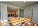 Relaxing outdoor patio with wooden dining set, sliding glass doors, and views of the modern kitchen at 7487 Oakmoss Loop, Davenport, FL 33837