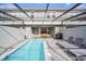 Backyard oasis with a screened-in pool, covered patio, dining area, and BBQ grill for outdoor gatherings at 7487 Oakmoss Loop, Davenport, FL 33837
