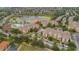 Stunning aerial view of a resort-style community with a pool, lake, and well-maintained landscaping at 7654 Comrow St # 104, Kissimmee, FL 34747