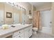Bright bathroom featuring a large mirror and vanity adjacent to the toilet and shower at 7654 Comrow St # 104, Kissimmee, FL 34747