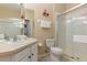 Well-lit bathroom with shower, bath and sink with a vanity and mirrored wall at 7654 Comrow St # 104, Kissimmee, FL 34747